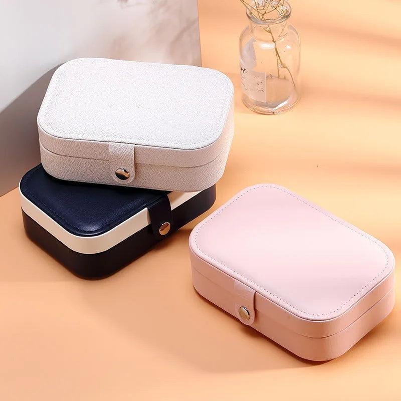 Caixa organizadora de joias com vários compartimentos para anéis, brincos e colares. Perfeita para manter acessórios protegidos e organizados, economizando espaço e otimizando a rotina diária com praticidade e elegância.